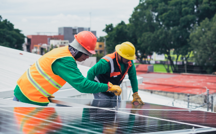 Solar technicians installing rooftop solar panels for renewable energy and sustainable power generation