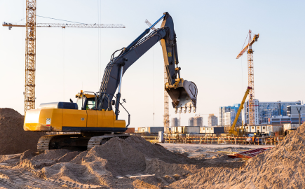 Heavy construction machinery working on industrial infrastructure development project