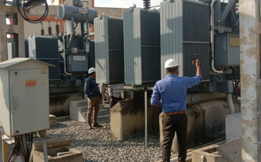 Engineers working on electrical transformer installation